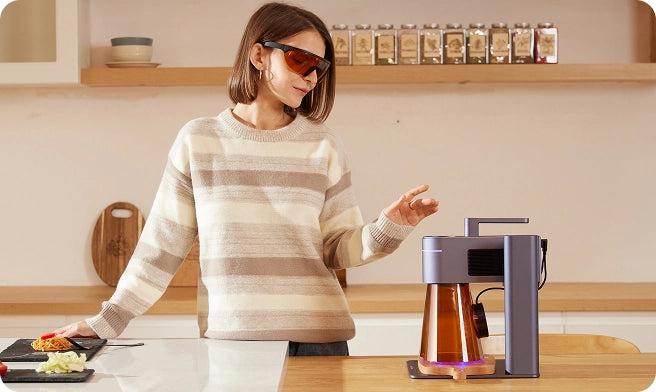 A home DIY enthusiast wearing laser safety goggles to safely operate the LaserPecker LP4 laser engraver.