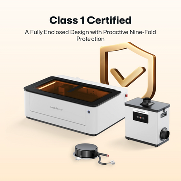 LaserPecker fully enclosed laser engraver system, featuring Class 1 laser safety certification and proactive nine-fold protection. The image includes the main engraver unit, an air purifier, and an accessory, emphasizing a safe, integrated workspace for laser processing.