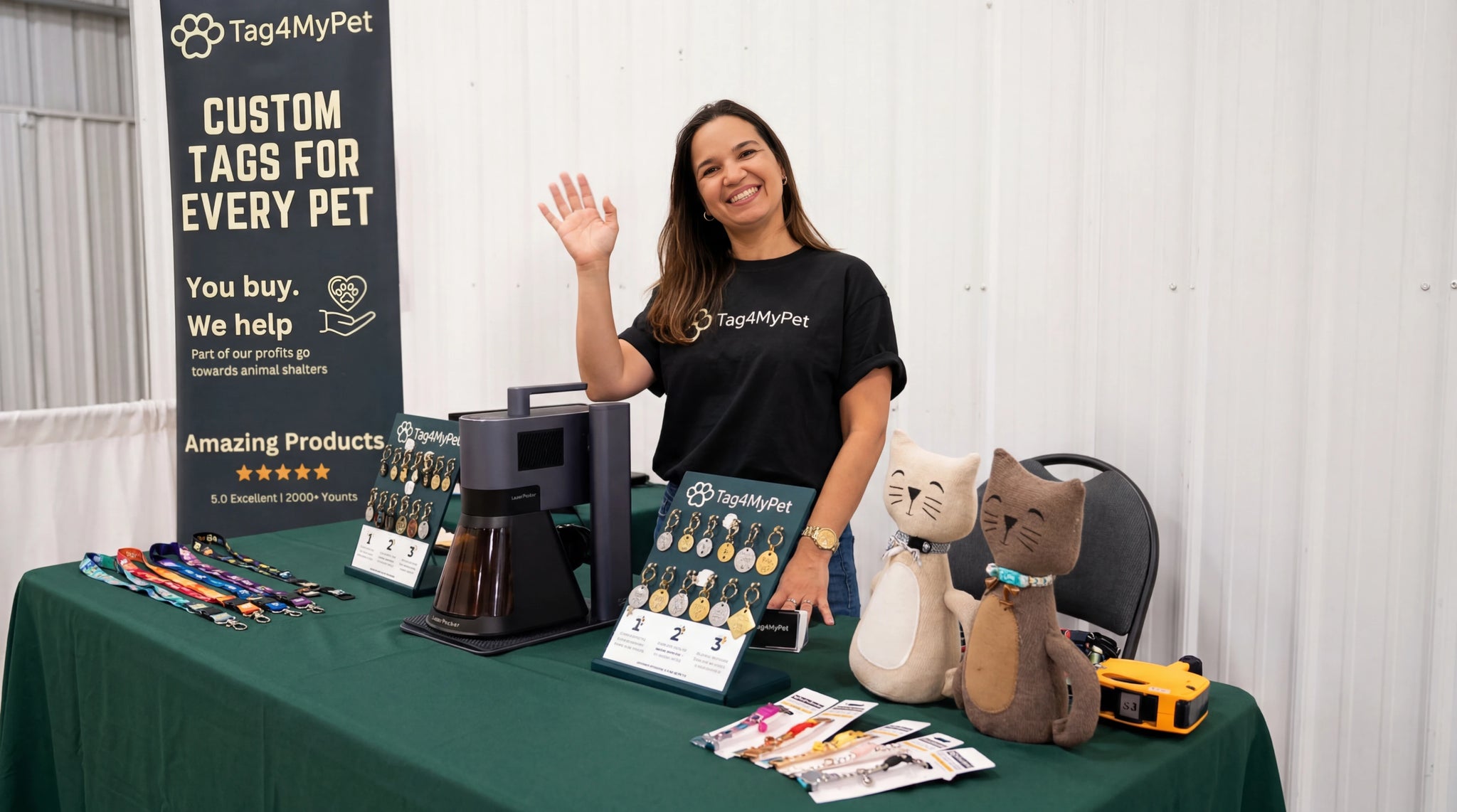 A woman presenting custom pet tags with a LaserPecker machine at a craft market booth.
