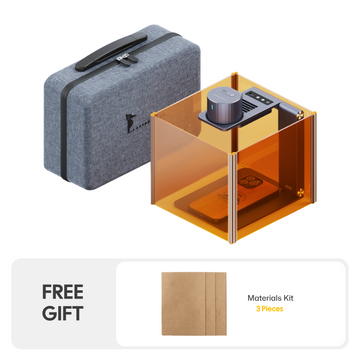 LaserPecker engraver complete kit, including an amber safety enclosure, a protective carrying case, and a free 3-piece materials kit, enabling safe, portable, and immediate engraving projects.